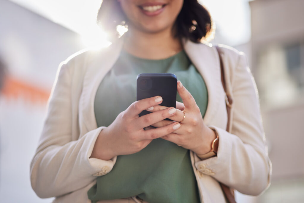 Phone, hands and a woman outdoor in a city with communication, internet connection and app. Closeup.